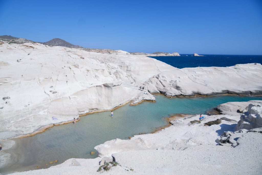 Turquoise lagoon amid white volcanic rock at Sarakiniko