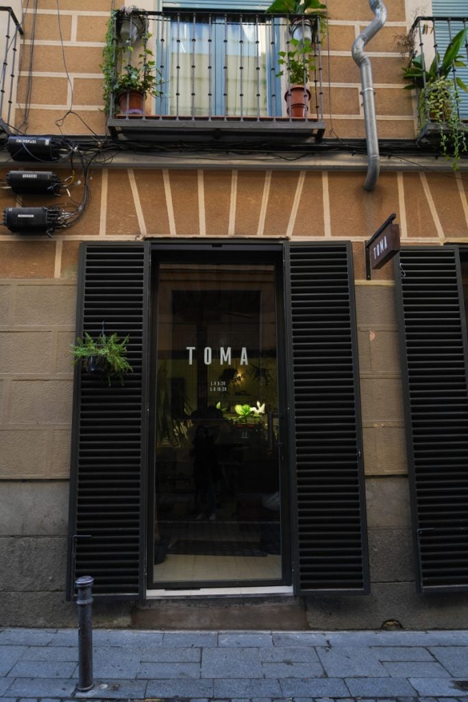 Toma coffee shop entrance with black shutters