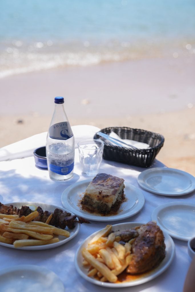 Greek dishes served at a beachside table at Tsikali