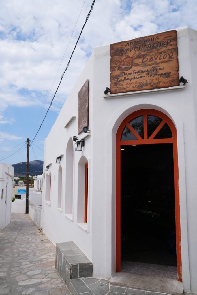 Whitewashed exterior of Veniou Bakery in Artemonas