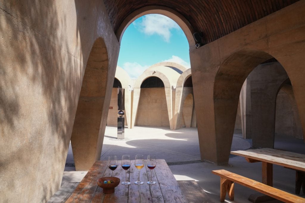 Wine tasting table in Pictograma Winery's arched courtyard